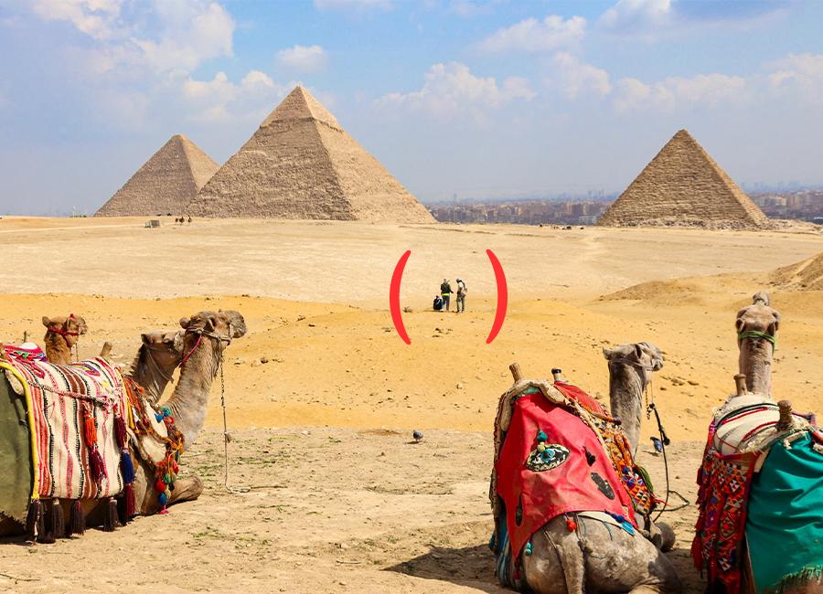 A group of happy people in front of the Great Pyramids of Giza, Egypt